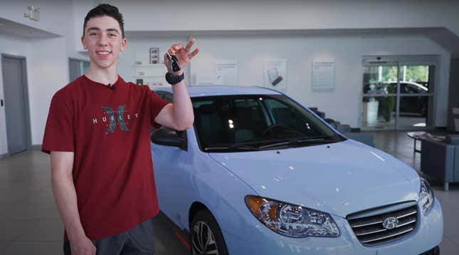 A photo of the Elantra;s new owner holding the keys in front of the car