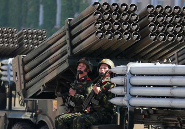 Soldiers riding a multiple-rocket launcher during the parade.