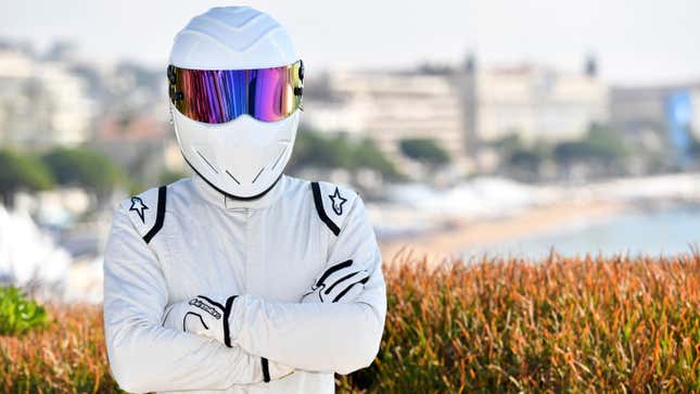 A photo of The Stig with its arms crossed. 