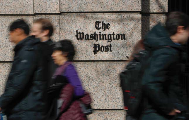 FILE - People walk by the One Franklin Square Building, home of The Washington Post newspaper, in downtown Washington on Feb. 21, 2019. The Washington Post plans to cut 240 jobs in the coming weeks through the offering of voluntary buyouts. In an email to staff, interim CEO Patty Stonesifer cited overly optimistic growth projections made in recent years. She said that the buyouts would be offered to certain jobs and departments, but didn’t specify which ones yet. (AP Photo/Pablo Martinez Monsivais, File)