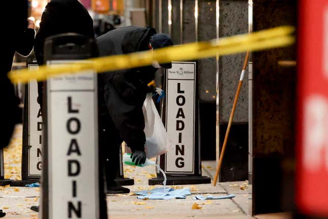 A worker cleans the sidewalk where Brian Thompson, a longtime UnitedHealth Group Inc. executive, was fatally shot.