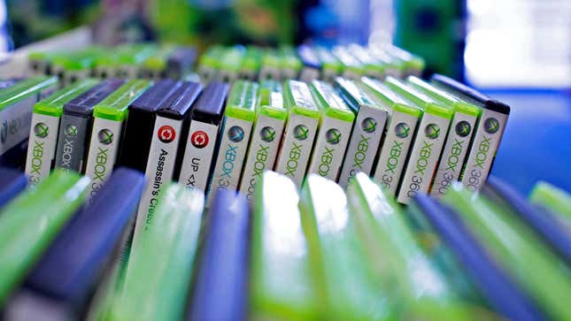 Xbox 360 games sit in cases at GameStop.