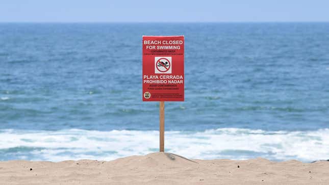 A sign indicates that the Dockweiler State Beach is closed to swimming after a sewage spill in Playa del Rey, in Los Angeles County, California.