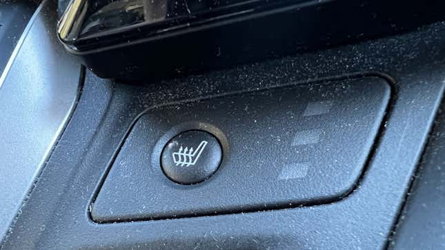 A photo of a heated seat switch in a car. 