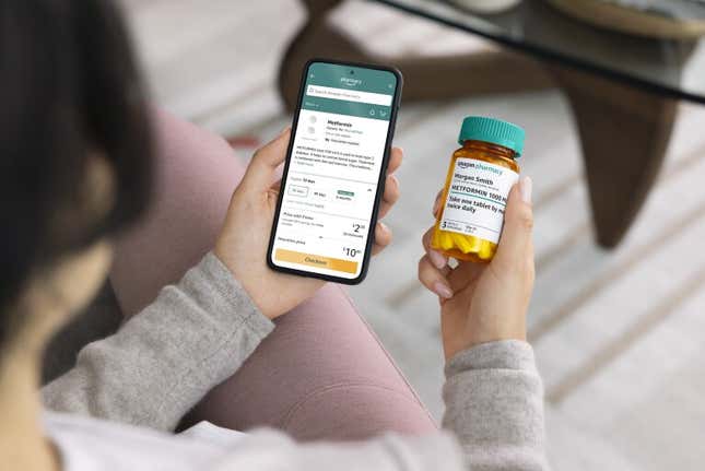 Woman looking at Amazon mobile app and prescription drug bottle. 