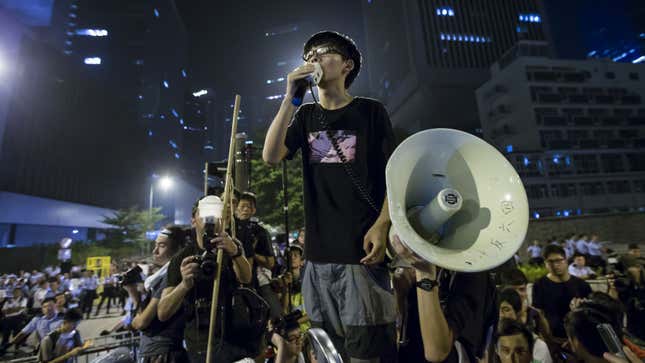 Joshua Wong, leader of the student movement, delivers a speech, outside the offices of Hong Kong's Chief Executive Leung Chun-ying in Hong Kong early October 3, 2014. Hong Kong's leader Leung told pro-democracy protesters late on Thursday that he had no intention of stepping down, and warned them that the consequences of occupying government buildings would be serious. REUTERS/Tyrone Siu