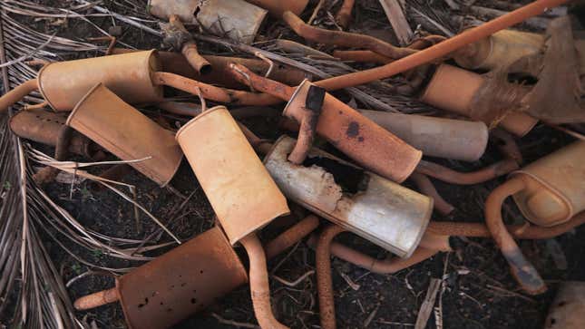 A pile of rusty car mufflers that have been abandoned. 