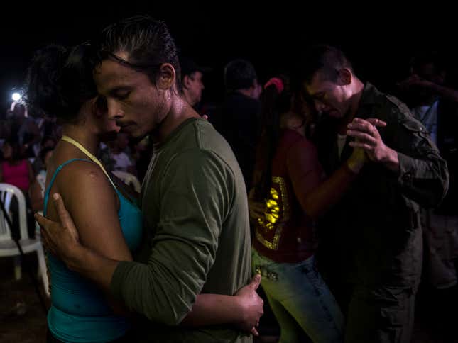 Two FARC members dance at a party during the group’s 10th guerrilla conference.