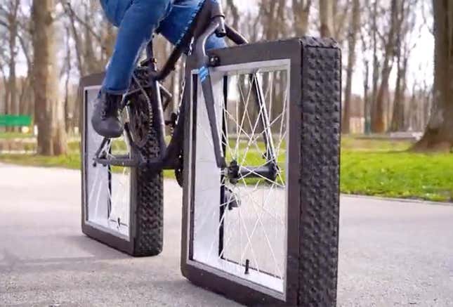 A bicycle with square wheels on a paved surface.