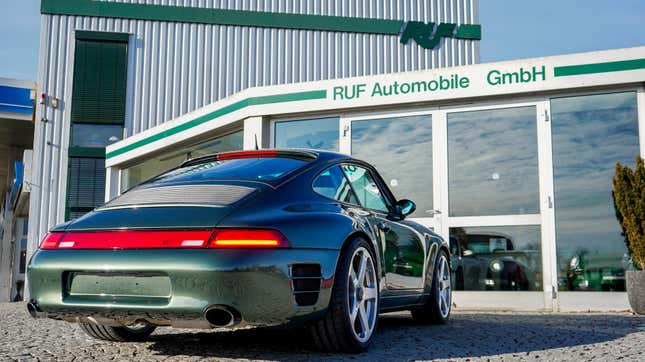 the rear of a green 993-bodied Ruf parked in front of the Ruf offices