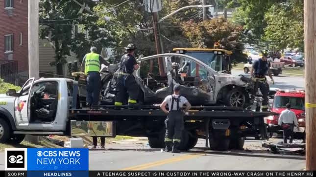 The wreckage of the Tesla on a truck's flatbed