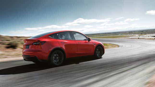 A red Tesla Model Y on a racetrack.