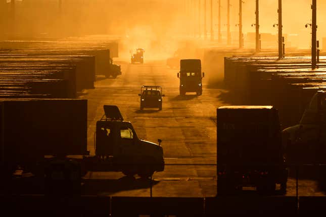 Workers drive among shipping containers and trailers at a BNSF intermodal terminal, Jan. 3, 2024, in Edgerton, Kan. On Wednesday, Feb. 28, 2024, the government issues the second of three estimates of GDP growth in the United States during the October-December quarter. (AP Photo/Charlie Riedel)