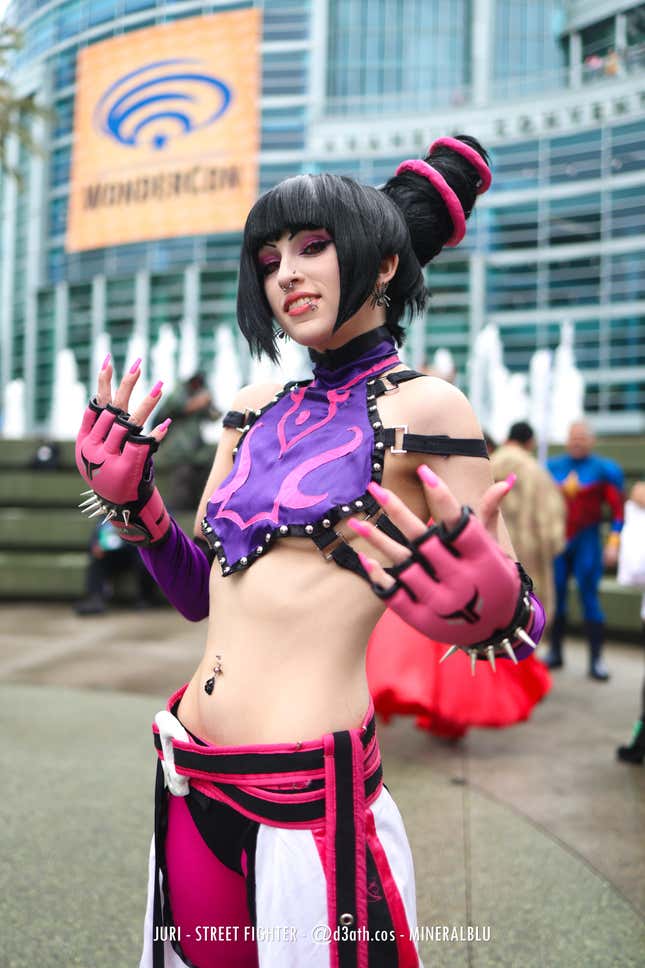 Juri poses with her arms outstretched.