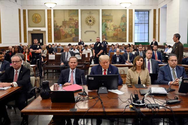 Former President Donald Trump sits between his lawyers Christopher Kise, left, and Alina Habba during his civil fraud trial at the State Supreme Court building in New York, Wednesday, Oct. 4, 2023. (Angela Weiss/Pool Photo via AP)