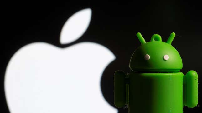 The Android mascot Bugdroid is seen in front of the Apple logo