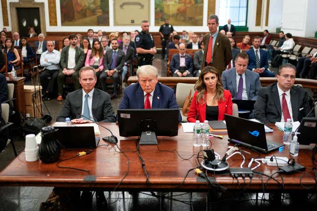 FILE - Former President Donald Trump, center, sits in the courtroom with his legal team before the continuation of his civil business fraud trial at New York Supreme Court, Tuesday, Oct. 3, 2023, in New York. Donald Trump’s lawyers asked a New York appeals court Friday to halt his Manhattan civil fraud trial while they fight a court ruling that calls for dissolving companies that control some of the former president’s most prized assets, including Trump Tower. (AP Photo/Seth Wenig, Pool)