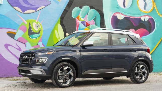 A Hyundai Venue parked in front of a colorful street mural