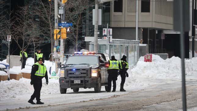 Police patrol the streets near Parliament Hill a day after they cleared a demonstration by truck drivers opposing vaccine mandates that had been entrenched for 23 days on February 20, 2022 in Ottawa, Ontario, Much of the area in downtown Ottawa near Parliament Hill has been declared a secure zone where only residents and people who can prove they have a valid purpose for entering are allowed past checkpoints. 