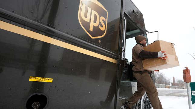 A UPS driver steps off his truck to deliver packages in Evanston, Illinois, March 5, 2014. United Parcel Service Inc, the world's largest courier company, said it would buy 1,000 propane-fueled delivery trucks and install 50 fueling stations in the United States as it expands its already-large fleet of alternative-fuel vehicles