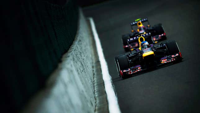 A photo of two Red Bull F1 cars racing on a track. 