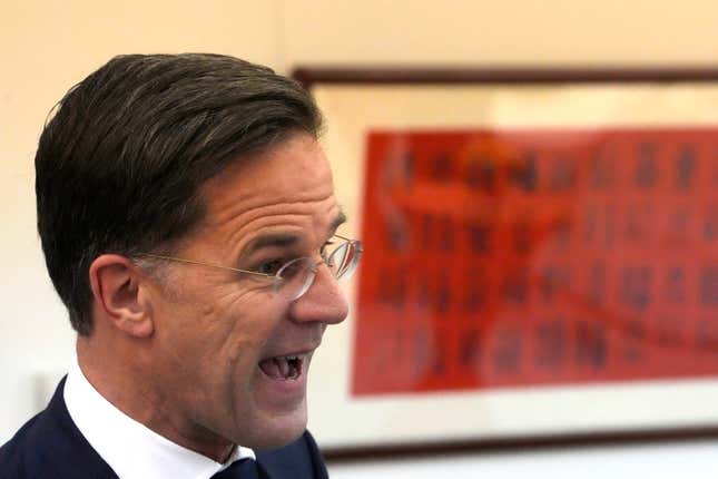 Dutch Prime Minister Mark Rutte speaks to journalists at the Dutch embassy near Chinese calligraphy on the wall in Beijing, Wednesday, March 27, 2024. Chinese leader Xi Jinping has told visiting Dutch Prime Minister Mark Rutte that attempts to restrict China&#39;s access to technology will not stop the country&#39;s advance. (AP Photo/Ng Han Guan)