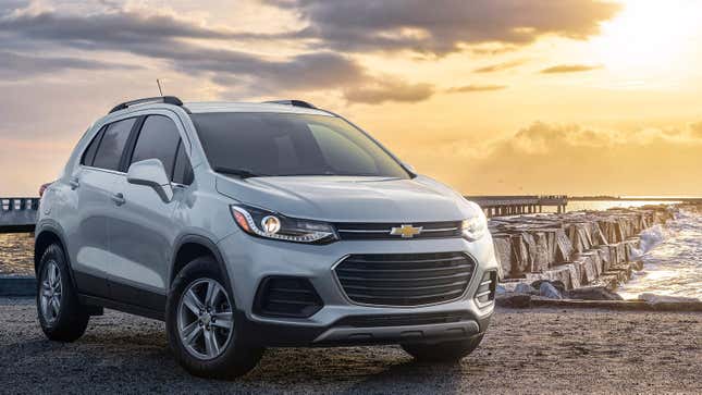 a silver chevy trax parked in front of the ocean