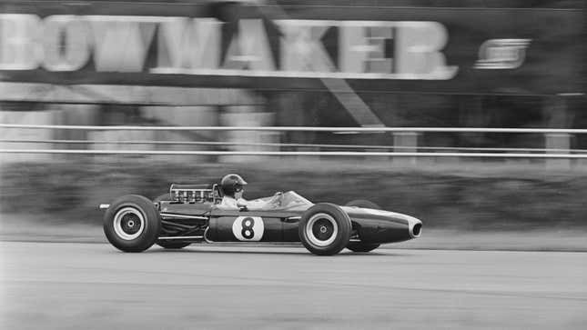 A black and white photo of Dan Gurney racing in F1. 