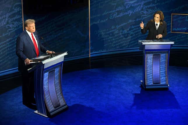 US Vice President and Democratic presidential candidate Kamala Harris (R) speaks as former US President and Republican presidential candidate Donald Trump listens during a presidential debate at the National Constitution Center in Philadelphia, Pennsylvania, on September 10, 2024.