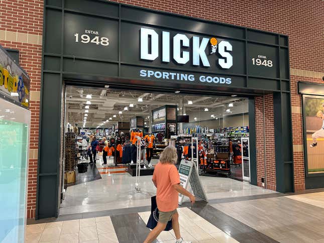 File - A shopper passes a Dick&#39;s Sporting Goods store on Aug. 24, 2023, in a shopping center in Lakewood, Colo. On Tuesday, the Conference Board reports on U.S. consumer confidence for October. (AP Photo/David Zalubowski, File)