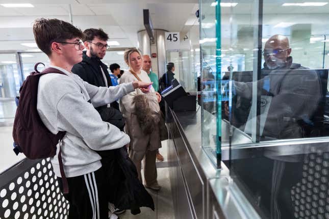 Piet De Staercke, from back right to left, with his wife Jill Bornauw, their eldest son Stan De Staercke, watch their youngest Tuur de Staercke, get screened by a Custom Border Protection officer, right, in the port of entry at Washington Dulles International Airport in Chantilly, Va. Monday, April 1, 2024. The Belgian family of four, used the Mobile Passport Control app, the newest technology in international travel, to ease their way to their port of entry. Within minutes they had bypassed a long line of people waiting at the airport&#39;s passport control and were waiting for their luggage. (AP Photo/Manuel Balce Ceneta)