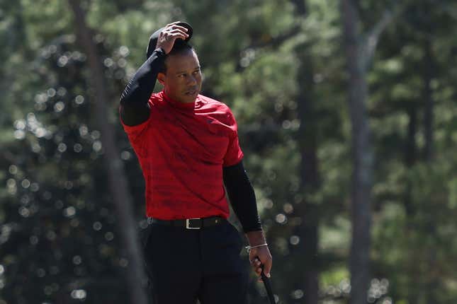 Tiger Woods tips his hat to the crowd on the 18th green after finishing his round during the final round of the Masters at Augusta National Golf Club on April 10, 2022 in Augusta, Georgia.
