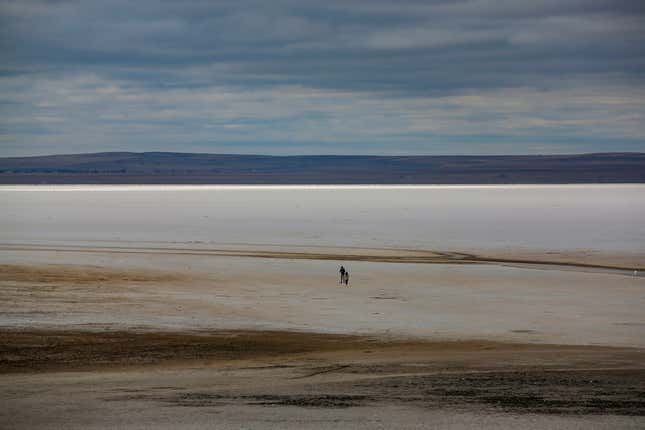 A man walks along Lake Tuz, Monday, Oct. 25, 2021.