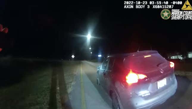 A police vehicle camera photo of a crossover SUV pulled over and missing two tires