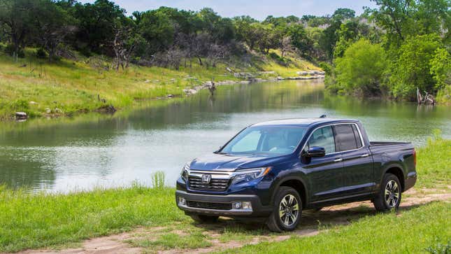 A Honda Ridgeline pickup truck in a field