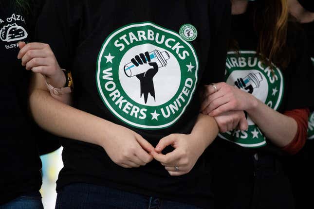 FILE - Starbucks employees and supporters link arms during a union election watch party Dec. 9, 2021, in Buffalo, N.Y. The U.S. Supreme Court is set to hear oral arguments in a case filed by Starbucks against the National Labor Relations Board. (AP Photo/Joshua Bessex, File)