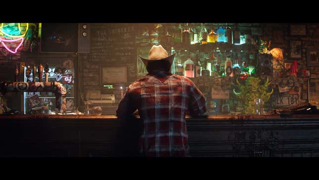 Wolverine sits at a bar with his back to the camera.