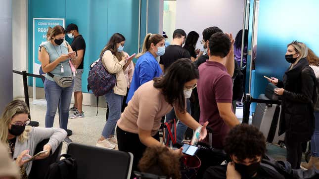 People crowd around a Covid-19 testing site at Miami International Airport on December 28, 2021 in Miami, Florida. 