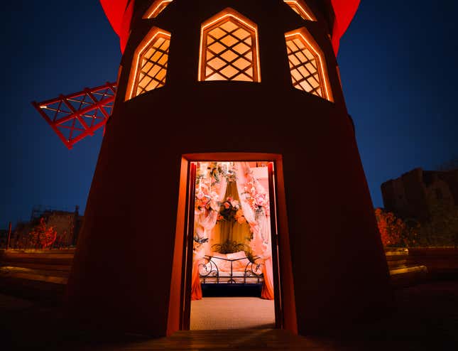 A photo of a hidden bedroom in the iconic windmill from Moulin Rouge is shown.