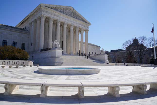 FILE - People stand on the steps of the U.S. Supreme Court, Feb.11, 2022, in Washington. The Supreme Court has agreed to take up a dispute over a medication used in the most common method of abortion in the United States. It’s the court’s first abortion case since it overturned Roe v. Wade last year. (AP Photo/Mariam Zuhaib, File)