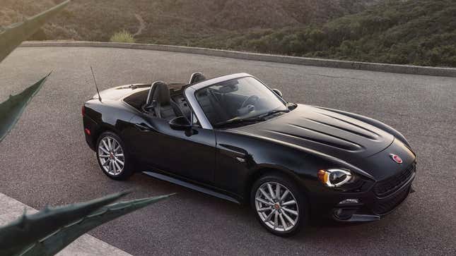 A photo of a black Fiat 124 Spider. 