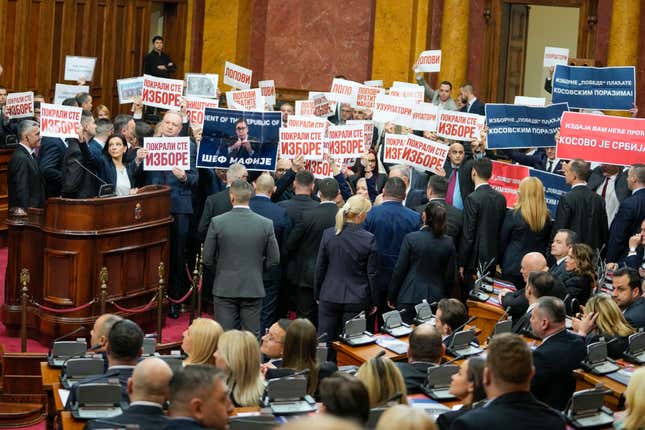 Opposition lawmakers hold banners reading: &quot;Stole the elections&quot; during a Serbia&#39;s parliament constitutive session in Belgrade, Serbia, Tuesday, Feb. 6, 2024. Serbia&#39;s National Assembly held an inaugural session on Tuesday as ruling nationalists ignored widespread reports that parliamentary and municipal elections held in December were marred by vote rigging and other irregularities. (AP Photo/Darko Vojinovic)