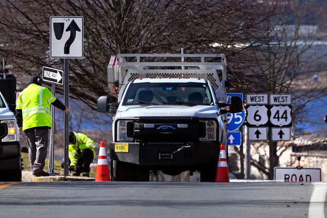 Rhode Island Department of Transportation workers replace a sign leading to the onramp to the Washington Bridge, Friday, March 8, 2024, in East Providence, R.I. The closure of a section of the bridge, and onramps, due to failure of some bridge components, has caused a significant loss to local businesses. (AP Photo/Charles Krupa)