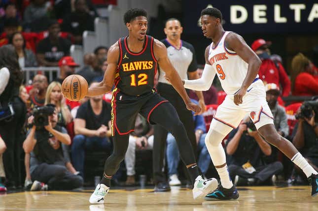 Oct 27, 2023; Atlanta, Georgia, USA; Atlanta Hawks forward De&#39;Andre Hunter (12) is defended by New York Knicks guard RJ Barrett (9) in the first quarter at State Farm Arena.