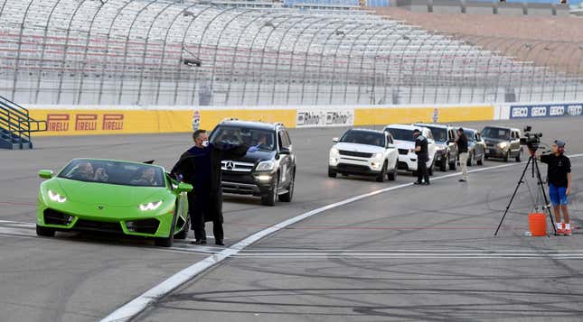 Steve Buuck, CEO der Faith Lutheran High School, überreicht einem Schüler, der einen Lamborghini Huracan fährt, während einer Abschlussfeier der Faith Lutheran auf dem Las Vegas Motor Speedway ein Diplom.