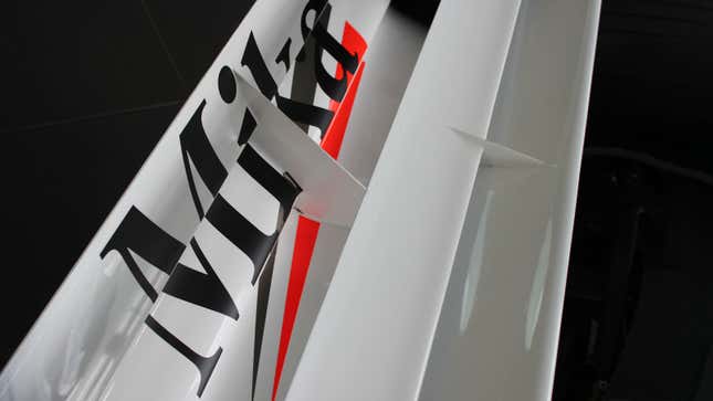 A photo of a McLaren F1 car's rear wing with "Mika" written across it. 