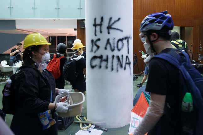 People walk inside the Legislative Council building after storming it in Hong Kong on July 1, 2019.