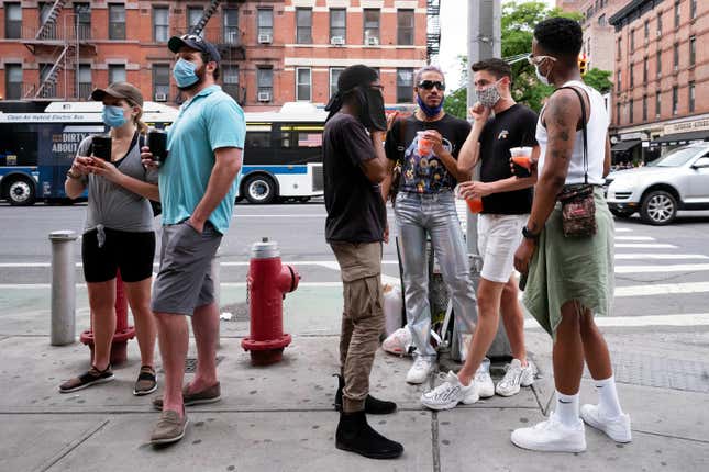 FILE - People gather on a street in the Hell&#39;s Kitchen neighborhood of New York while waiting to get takeout drinks at a bar, May 29, 2020. New York could expand access to booze by allowing movie theaters to sell liquor and continuing to let people buy takeout cocktails from bars and restaurants under a series of measures unveiled on Thursday, April 18, 2024. (AP Photo/Mark Lennihan, File)