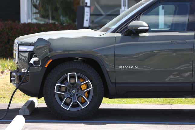 A Rivian electric pickup truck sits in a parking lot at a Rivian service center on May 09, 2022 in South San Francisco, California. Shares of Rivian stock fell 13 percent after Ford, which currently owns as 11.4 percent stake in the electric car maker, is planning to sell 8 million of its 102 million shares.