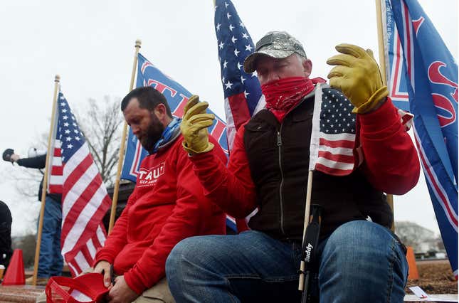 Supporters of US President Donald Trump hold a rally outside the US Capitol as they protest the upcoming electoral college certification of Joe Biden as US President in Washington, DC on January 6, 2021.